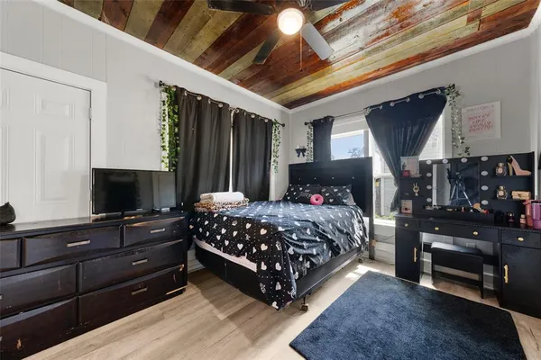 a bedroom with a bed and a television
