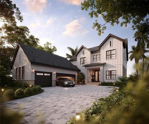 a front view of a house with a garden and parking