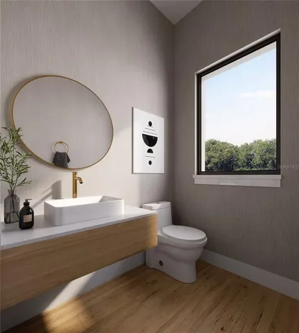 a bathroom with a toilet a sink and mirror
