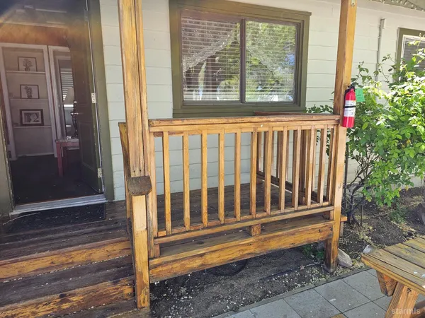 a view of a wooden bench in the porch