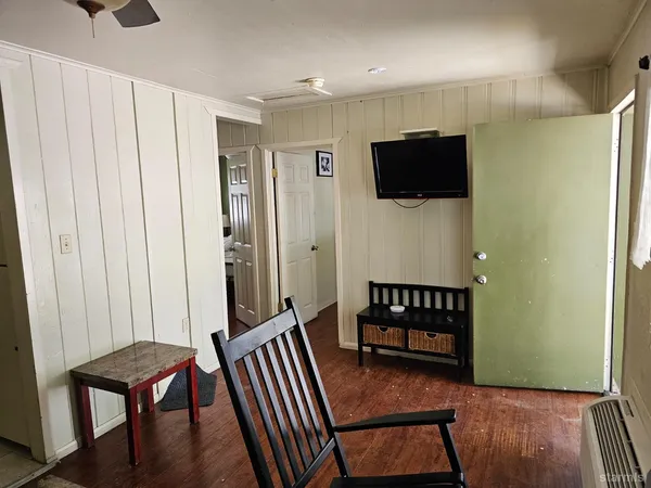 a view of a livingroom with furniture wooden floor and window