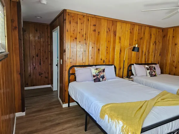 a bedroom with a bed and a mirror