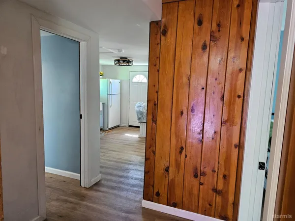 a view of a hallway with wooden floor
