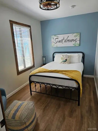 a bedroom with a bed and a chair
