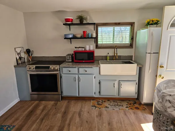 a kitchen with stainless steel appliances granite countertop a stove and a refrigerator