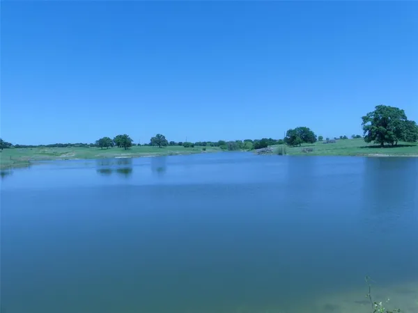 a view of a lake with houses in the background