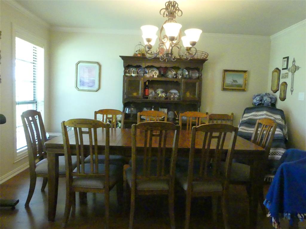 3421 Schoolhouse Road Forestburg, TX 76239 - Photo 13 of 39 a view of a dining room with furniture and chandelier