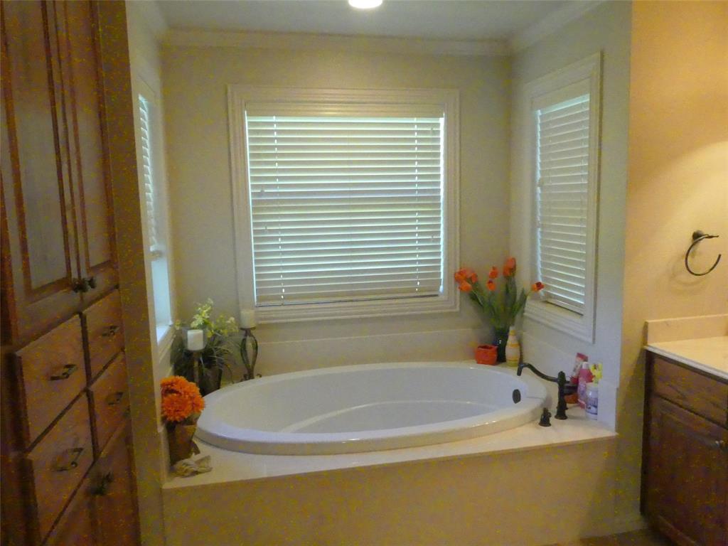 3421 Schoolhouse Road Forestburg, TX 76239 - Photo 16 of 39 a white bath tub sitting next to a white sink