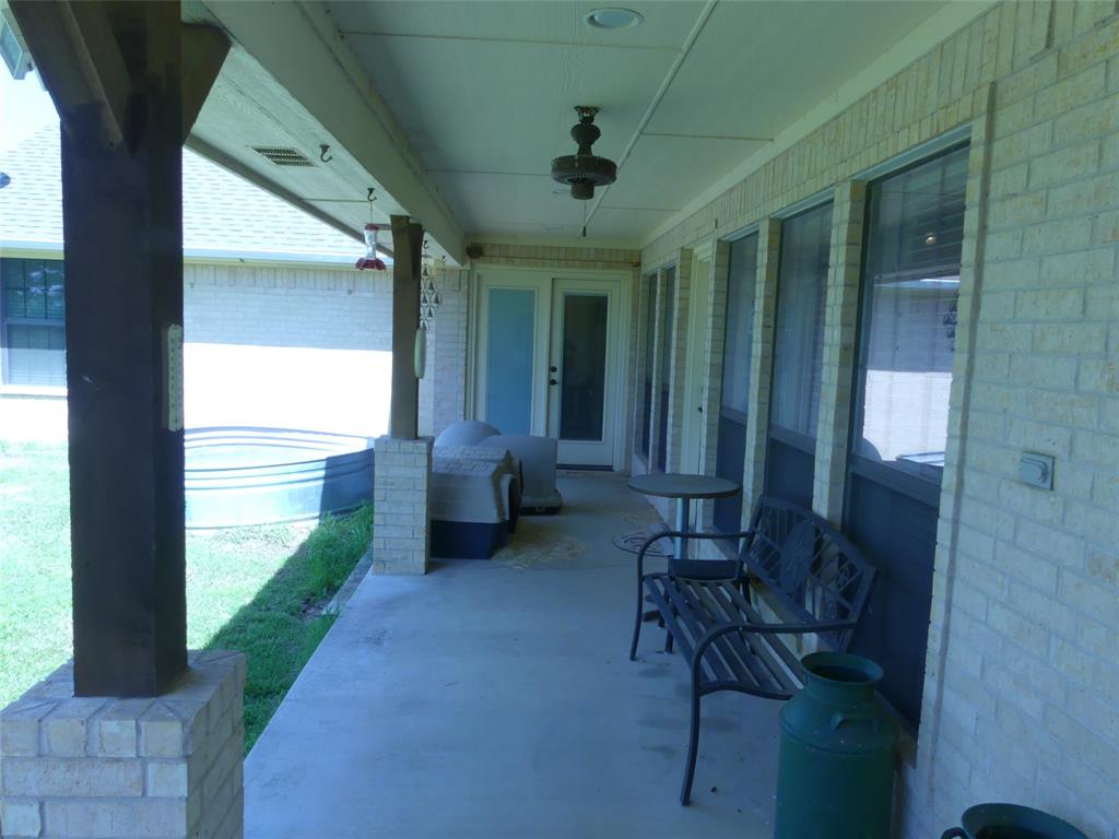 3421 Schoolhouse Road Forestburg, TX 76239 - Photo 19 of 39 a view of a porch with furniture and a yard