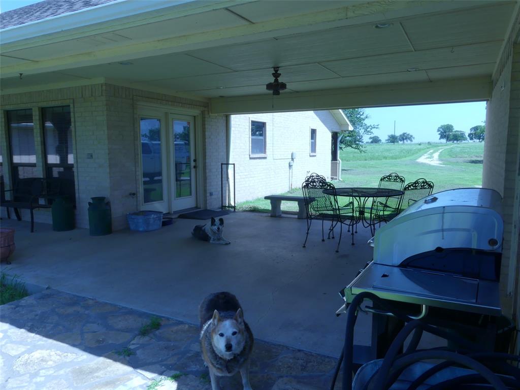 3421 Schoolhouse Road Forestburg, TX 76239 - Photo 21 of 39 a backyard of a house with table and chairs