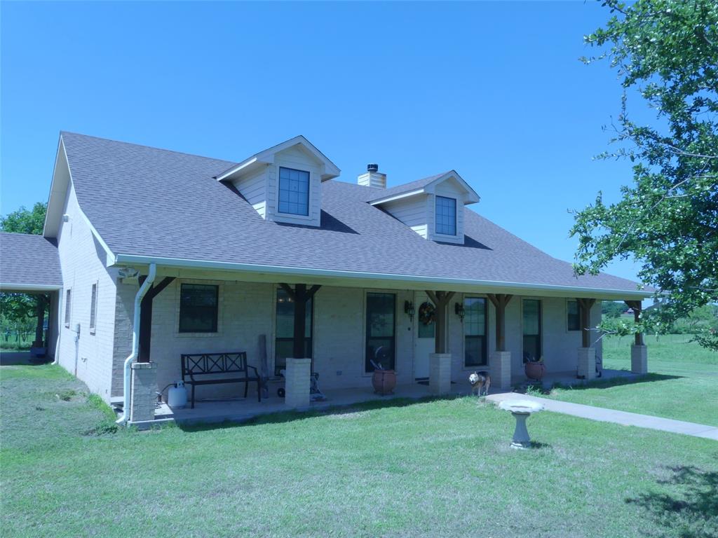 3421 Schoolhouse Road Forestburg, TX 76239 - Photo 22 of 39 a front view of a house with a garden