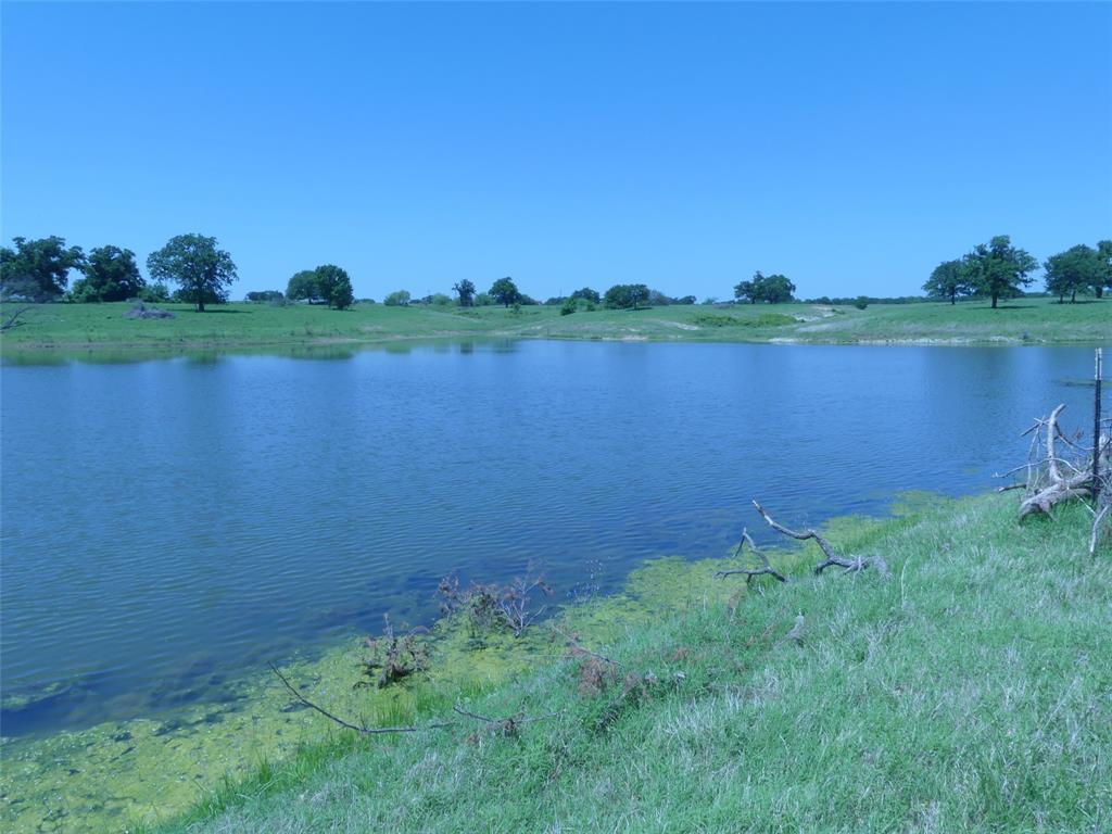 3421 Schoolhouse Road Forestburg, TX 76239 - Photo 32 of 39 a view of a lake with a big yard