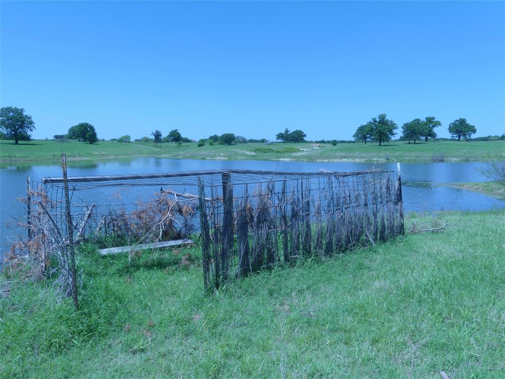3421 Schoolhouse Road Forestburg, TX 76239 - Photo 33 of 39 a view of a backyard with mountain view and a lake view