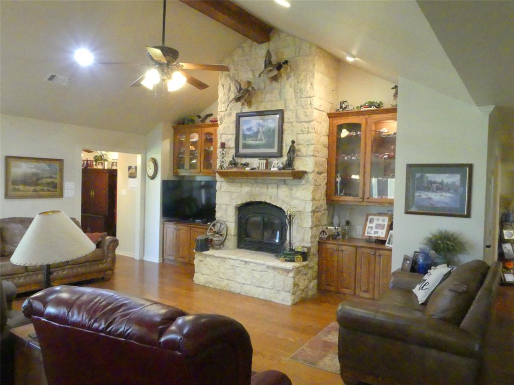 3421 Schoolhouse Road Forestburg, TX 76239 - Photo 4 of 39 a living room with furniture and a fireplace