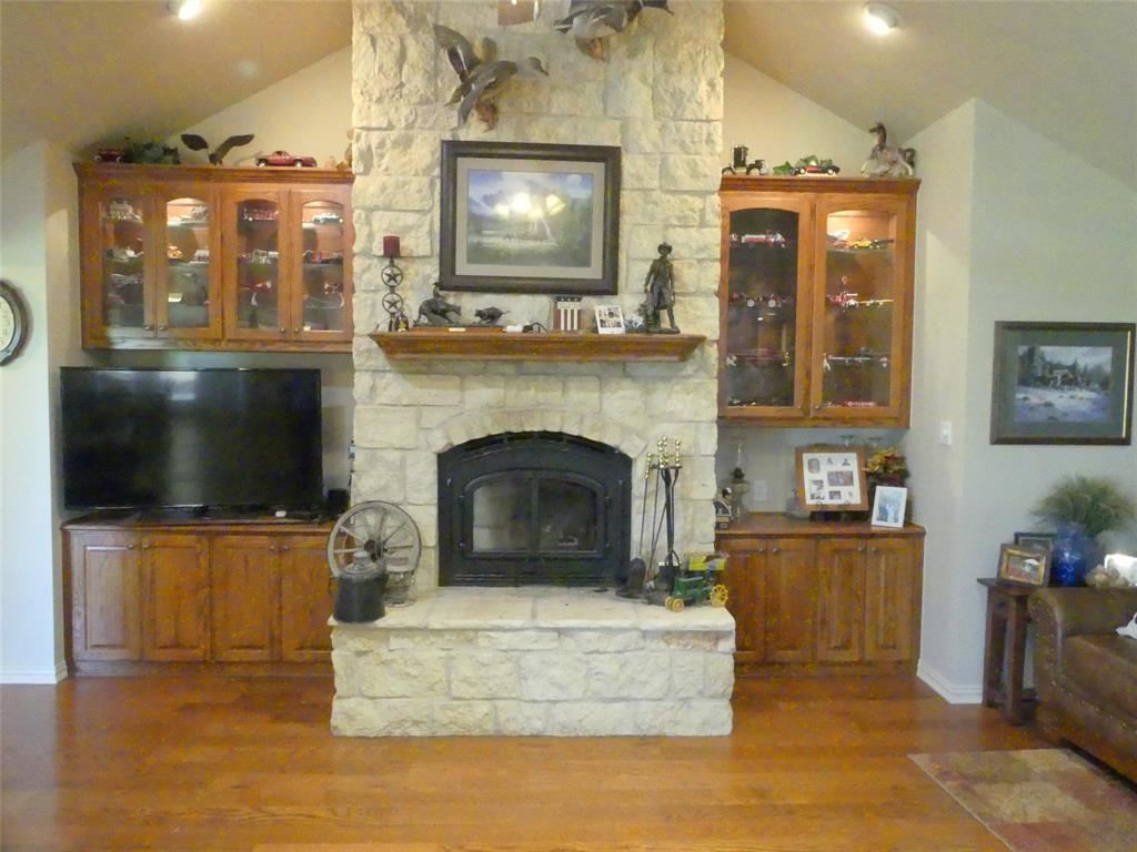 3421 Schoolhouse Road Forestburg, TX 76239 - Photo 5 of 39 a living room with fireplace furniture and a flat screen tv