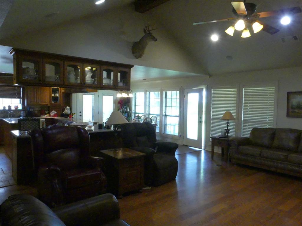 3421 Schoolhouse Road Forestburg, TX 76239 - Photo 9 of 39 a living room with furniture and a chandelier