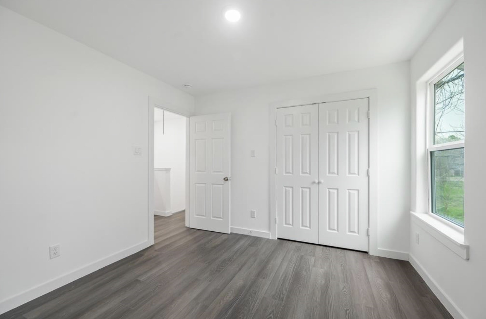 7804 Crestview Drive, Unit B Houston, TX 77028 - Photo 13 of 18 a view of an empty room with wooden floor and a window
