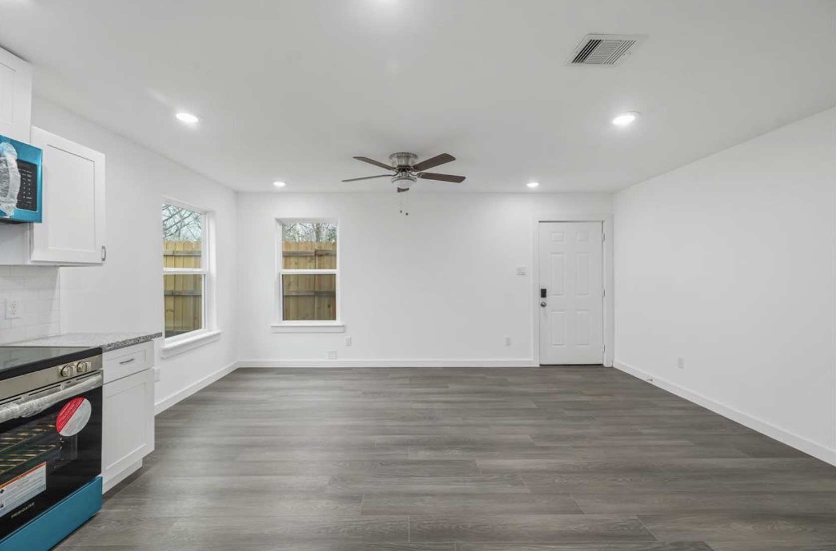 7804 Crestview Drive, Unit B Houston, TX 77028 - Photo 2 of 18 a view of an empty room with a window and wooden floor