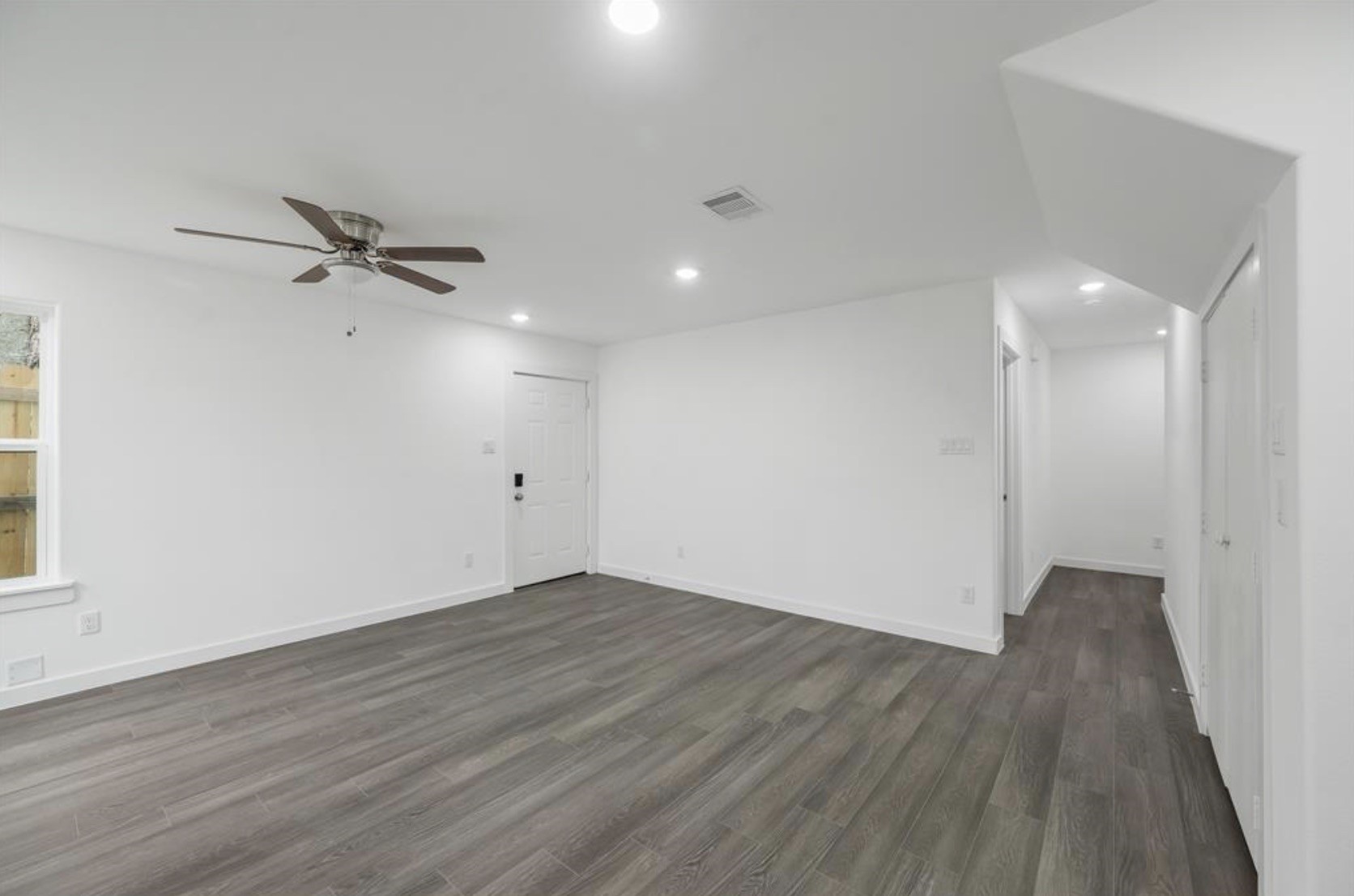 7804 Crestview Drive, Unit B Houston, TX 77028 - Photo 8 of 18 wooden floor in an empty room with a window