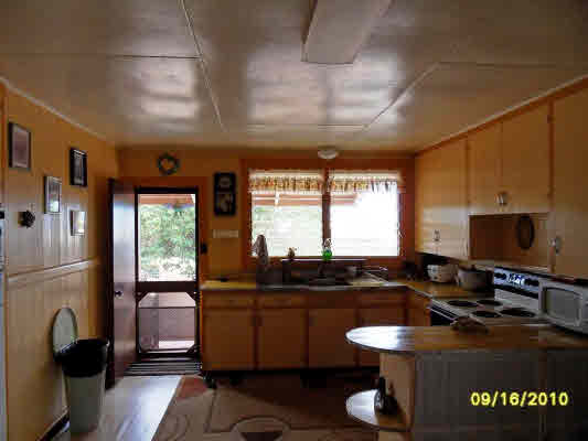 3510 Eleu Road Hanapepe, HI 96716 - Photo 9 of 10 a kitchen with a sink stove and refrigerator