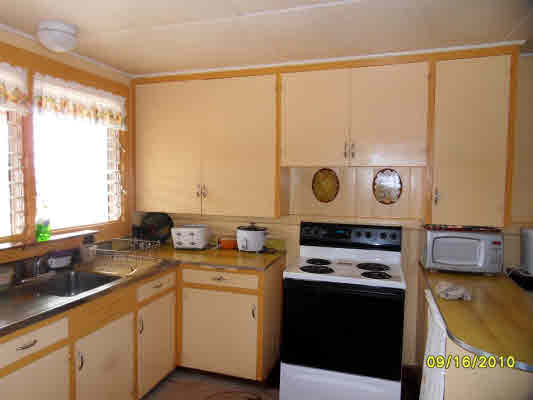 3510 Eleu Road Hanapepe, HI 96716 - Photo 10 of 10 a kitchen with a sink stove and microwave