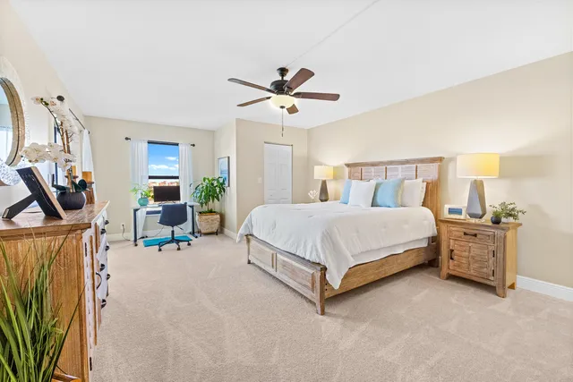 a bedroom with a bed a couch and a chandelier