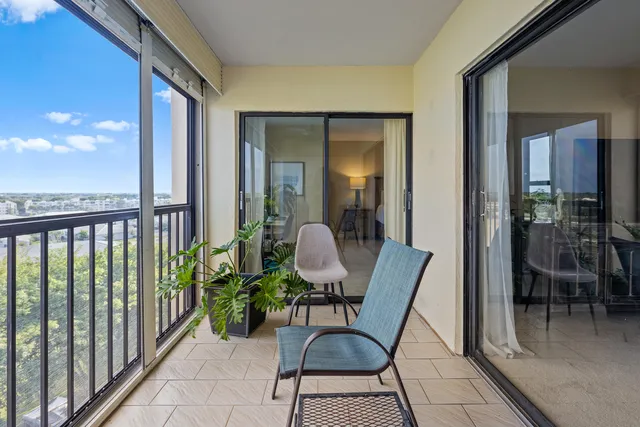 a view of a chairs and table in a balcony