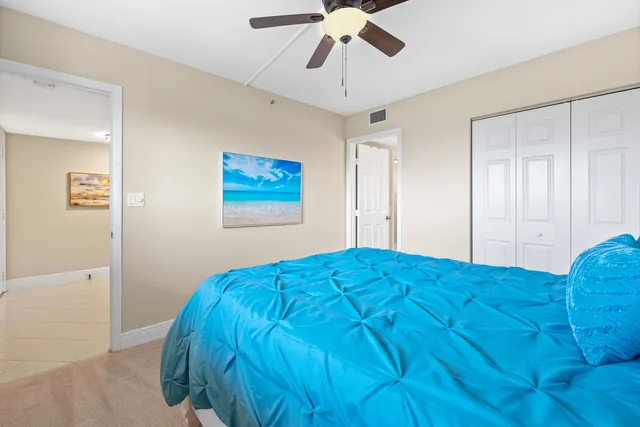 a bedroom with a bed and painting on the wall