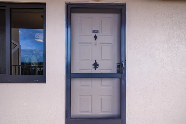 a view of a hallway with potted plants