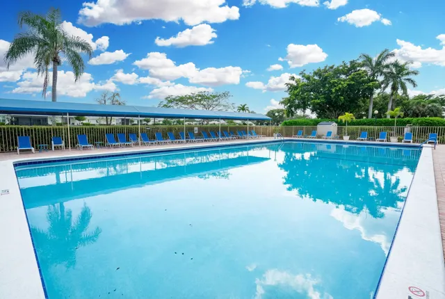 a view of a swimming pool with a yard