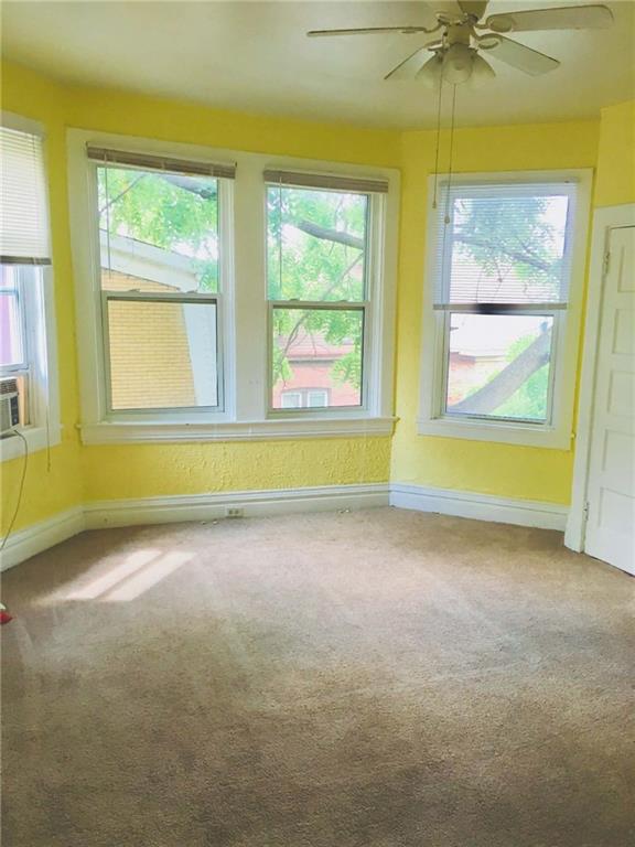 1911 Delaware Avenue Pittsburgh, PA 15218 - Photo 11 of 17 an empty room with a window and a ceiling fan