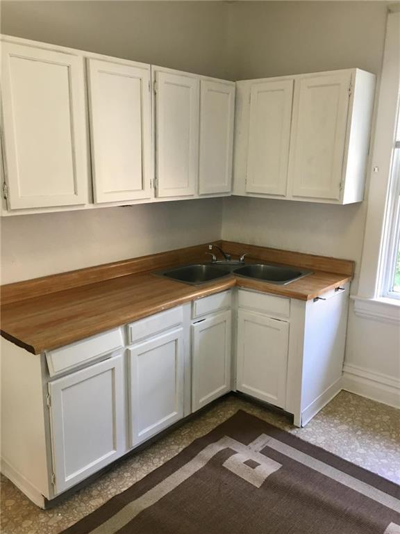 1911 Delaware Avenue Pittsburgh, PA 15218 - Photo 13 of 17 a kitchen with granite countertop white cabinets and sink