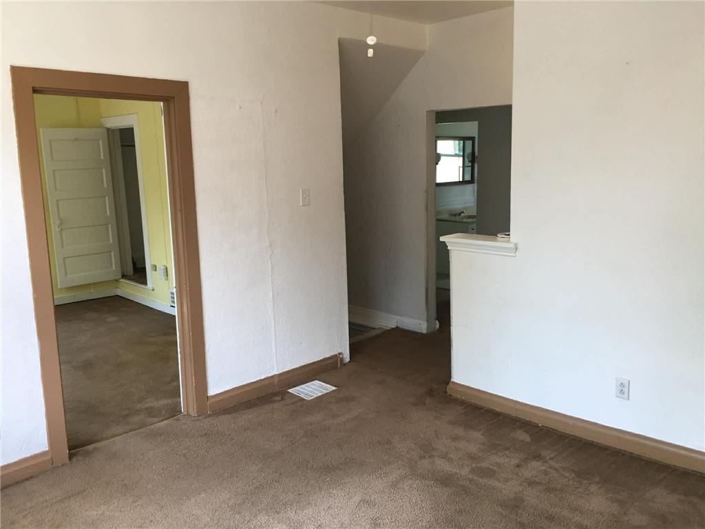 1911 Delaware Avenue Pittsburgh, PA 15218 - Photo 16 of 17 an empty room with mirror and a bathroom