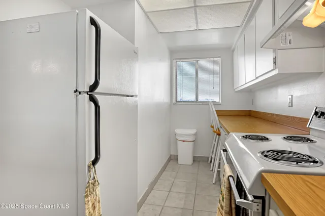 a kitchen with a stove and a refrigerator