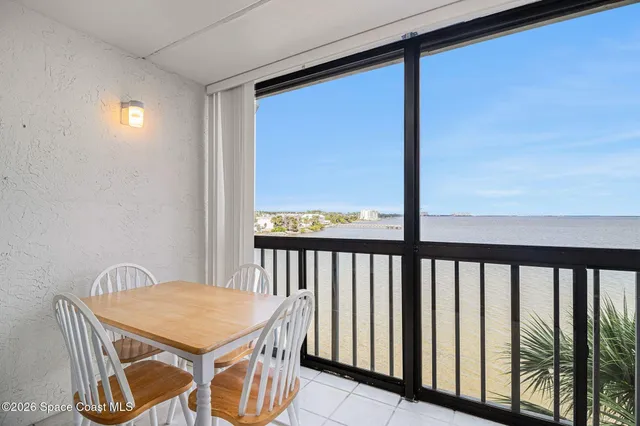 a view of a balcony with a table and chairs