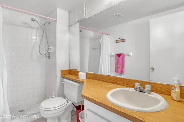 a bathroom with a sink toilet tub and shower