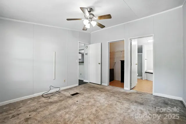 a view of a livingroom with a chandelier fan