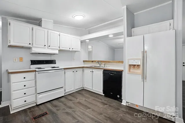 a kitchen with cabinets appliances and a window