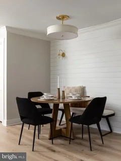 a view of a dining room with furniture and chandelier
