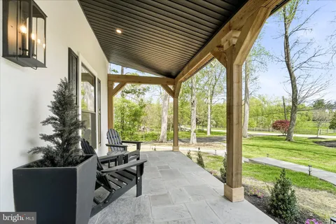 a building outdoor space with patio furniture and garden