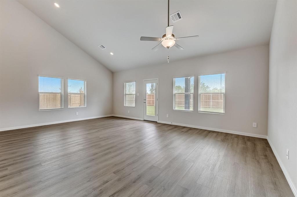 1405 Winters Way McKinney, TX 75071 - Photo 10 of 32 Spare room with light hardwood / wood-style flooring, high vaulted ceiling, and ceiling fan