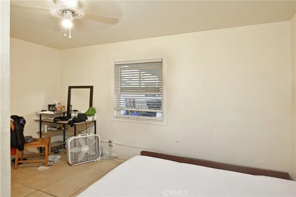 a room with chandelier fan and table