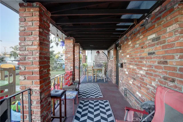 a view of a porch with wooden chairs