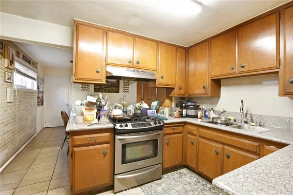 a kitchen with a sink stove and cabinets