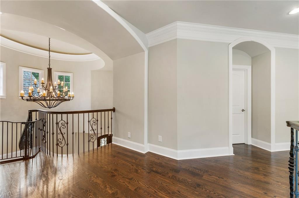 14560 Wood Road Milton, GA 30004 - Photo 35 of 74 a view of a hallway with wooden floor and chandelier