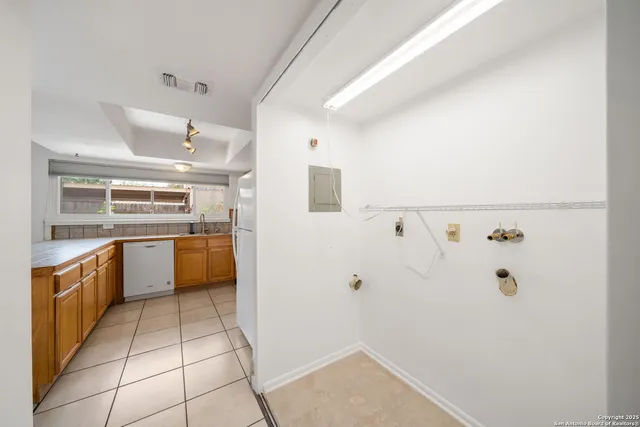 a large white kitchen with cabinetry