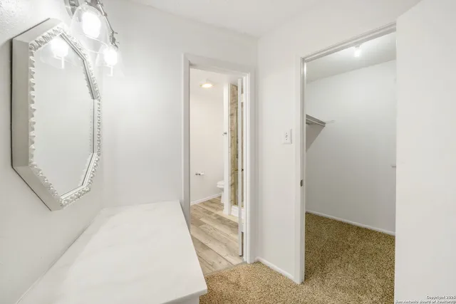 a view of a bathroom with a sink and mirror