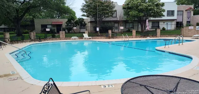 a view of a swimming pool with chairs