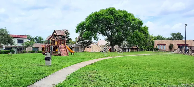 a childrens park with lots of swings and slides