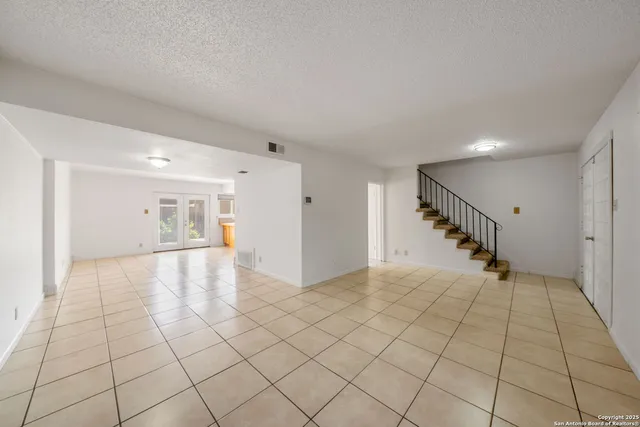 a view of a hallway to closet and natural light